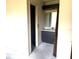 Bathroom featuring a vanity with a framed mirror, wood doors, and functional layout ready for updates at 9722 Kenton Rd, Wesley Chapel, FL 33545