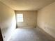 A blank canvas bedroom space ready for personalization, featuring a window for natural light, and outlets for convenience at 9722 Kenton Rd, Wesley Chapel, FL 33545