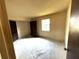Bedroom space featuring closet doors, window, and functional layout, ready for personalization and customization at 9722 Kenton Rd, Wesley Chapel, FL 33545