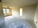 Unfurnished bedroom with ceiling fan, window, and access doorway at 9722 Kenton Rd, Wesley Chapel, FL 33545