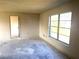 Bare bedroom featuring natural light from a large window and an access doorway at 9722 Kenton Rd, Wesley Chapel, FL 33545