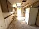 Kitchen space awaiting remodel, showcasing wood cabinets, refrigerator, and functional layout with room for modernization at 9722 Kenton Rd, Wesley Chapel, FL 33545