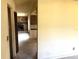 View of the living room featuring a stone fireplace, connecting to the kitchen and hallway at 9722 Kenton Rd, Wesley Chapel, FL 33545