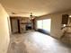 Living room featuring a stone fireplace, ceiling fan, sliding glass door, and layout ready for remodeling and personalization at 9722 Kenton Rd, Wesley Chapel, FL 33545