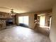 View of a living room, showcasing the fireplace and connecting kitchen space at 9722 Kenton Rd, Wesley Chapel, FL 33545