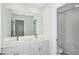 Bright bathroom featuring a double vanity with modern fixtures and a shower/tub combo at 10017 Surrey Rose Dr, San Antonio, FL 33576