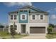Charming two-story home features a neutral color palette, an attached two car garage and well maintained lawn at 10017 Surrey Rose Dr, San Antonio, FL 33576