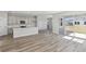Bright open living area seamlessly connects to a modern kitchen, perfect for a cozy and integrated home experience at 10017 Surrey Rose Dr, San Antonio, FL 33576