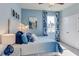 Cozy bedroom with bright blue walls, stylish decor, and a comfortable bed, offering a relaxing space at 10421 Gentle Rain Dr, Land O Lakes, FL 34638