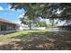 Backyard with mature trees and a white privacy fence at 10435 Tassel St, Spring Hill, FL 34608
