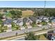 Aerial view showcasing single-Gathering homes in a well-maintained neighborhood with a big green park perfect for outdoor activities at 10625 Cardera Dr, Riverview, FL 33578