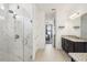 Bright bathroom features a tiled shower and granite countertops and opens to the main bedroom at 10625 Cardera Dr, Riverview, FL 33578