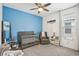 Bedroom features a gray crib, blue accent wall, nautical decor, and window for natural light at 10625 Cardera Dr, Riverview, FL 33578