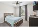 Bedroom featuring a wooden bed frame, ceiling fan, and window with natural light at 10625 Cardera Dr, Riverview, FL 33578