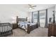 Bedroom featuring a wooden bed frame, nightstands, windows, and a baby crib at 10625 Cardera Dr, Riverview, FL 33578