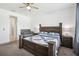 Bright bedroom features a ceiling fan, crib, and wood furniture at 10625 Cardera Dr, Riverview, FL 33578