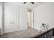 Neutral bedroom with double closet doors and an open doorway to another room at 10625 Cardera Dr, Riverview, FL 33578