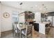 Contemporary dining space featuring modern fixtures and view into the kitchen, perfect for entertaining at 10625 Cardera Dr, Riverview, FL 33578