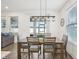 Bright dining room featuring modern pendant lighting and natural light streaming through multiple windows at 10625 Cardera Dr, Riverview, FL 33578