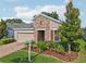 Well-maintained home with a brick-accented facade, landscaped front yard, and a two-car garage at 10625 Cardera Dr, Riverview, FL 33578