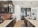 Kitchen with stainless steel appliances, granite countertops, dark wood cabinets, and brick backsplash at 10625 Cardera Dr, Riverview, FL 33578