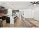Open floor plan showcasing the kitchen island with seating and stainless appliances from the living area at 10625 Cardera Dr, Riverview, FL 33578