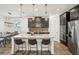 Kitchen with dark wood cabinets, granite countertops, stainless steel appliances, and pendant lighting at 10625 Cardera Dr, Riverview, FL 33578