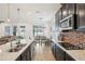Spacious open kitchen with stainless appliances, granite counters, and view of the dining and living areas at 10625 Cardera Dr, Riverview, FL 33578