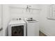 Bright laundry room with modern, white, front-loading washer and dryer appliances at 10625 Cardera Dr, Riverview, FL 33578