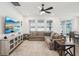 Bright living room features a comfortable sectional sofa, large windows, and sliding glass doors to the outdoors at 10625 Cardera Dr, Riverview, FL 33578
