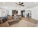 Open concept living space featuring a kitchen island and breakfast bar seating area, along with hardwood flooring at 10625 Cardera Dr, Riverview, FL 33578