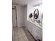 Bright bathroom with a double sink vanity, neutral tile, and good lighting creating a welcoming space at 11201 122Nd Ave # 126, Largo, FL 33778