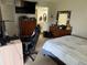 A clean bedroom with comfortable furnishings, including a wooden dresser and a computer desk and a view to the bathroom at 11201 122Nd Ave # 126, Largo, FL 33778