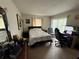 A neutral bedroom with a comfortable bed, desk area and an armchair near the window at 11201 122Nd Ave # 126, Largo, FL 33778
