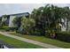 Well-maintained exterior with mature landscaping and lush hedges bordering the sidewalk at 11201 122Nd Ave # 126, Largo, FL 33778