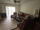Inviting living room featuring sliding glass doors, a ceiling fan and comfortable seating at 11201 122Nd Ave # 126, Largo, FL 33778