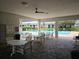 Relaxing poolside patio area with tables and chairs, perfect for enjoying the community pool at 11201 122Nd Ave # 126, Largo, FL 33778