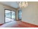 Dining area with chandelier and sliding glass doors to a screened patio area, great for entertaining at 11325 Glenmont Dr, Tampa, FL 33635
