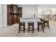 Basement bar has granite counters, wood cabinets, bar seating and custom tile backsplash at 11624 Calf Path Dr, Tampa, FL 33626