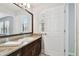 Bathroom features granite countertop, dark wood cabinets, and a large framed mirror at 11624 Calf Path Dr, Tampa, FL 33626
