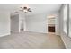 Primary bedroom features a ceiling fan, neutral carpet, and a bathroom ensuite at 11624 Calf Path Dr, Tampa, FL 33626