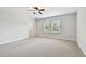 Spacious bedroom features natural light from two windows and neutral carpet at 11624 Calf Path Dr, Tampa, FL 33626