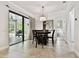 Bright dining area features a modern chandelier and access to a screened-in lanai at 11624 Calf Path Dr, Tampa, FL 33626