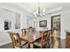 Elegant dining room with hardwood floors, chandelier lighting, and stylish furnishings for sophisticated dining at 11624 Calf Path Dr, Tampa, FL 33626