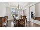 Elegant dining room features hardwood floors, a chandelier, and a large window with natural light at 11624 Calf Path Dr, Tampa, FL 33626