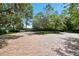 Circular brick driveway lined with mature trees and landscaping at 11624 Calf Path Dr, Tampa, FL 33626
