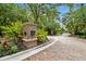 Brick-paved entrance leads to a gated community with lush greenery and a secure, welcoming atmosphere at 11624 Calf Path Dr, Tampa, FL 33626