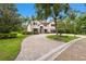 Stately home showcasing lush landscaping, a paver driveway, and an inviting facade, with great curb appeal at 11624 Calf Path Dr, Tampa, FL 33626