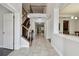 Grand foyer with tile flooring, staircase, and dining room view, creating an inviting entrance at 11624 Calf Path Dr, Tampa, FL 33626
