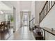 Welcoming foyer with tile flooring, staircase, and dining room view, creating an inviting entrance at 11624 Calf Path Dr, Tampa, FL 33626
